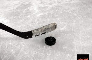 The Irina Foundation Is Real Now, and Honestly, We Need a Minute An ice hockey stick and puck resting on rink ice